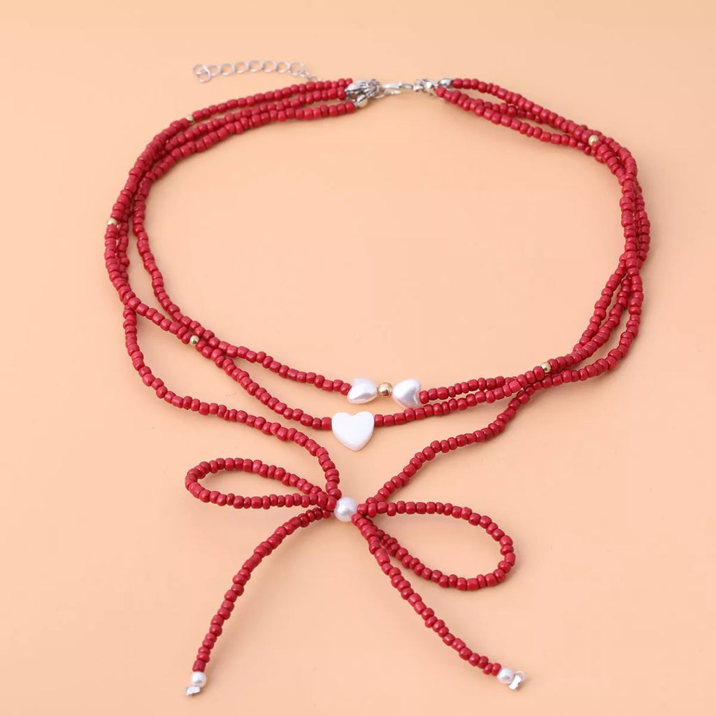 Beaded Bow Necklace with Heart Pendants