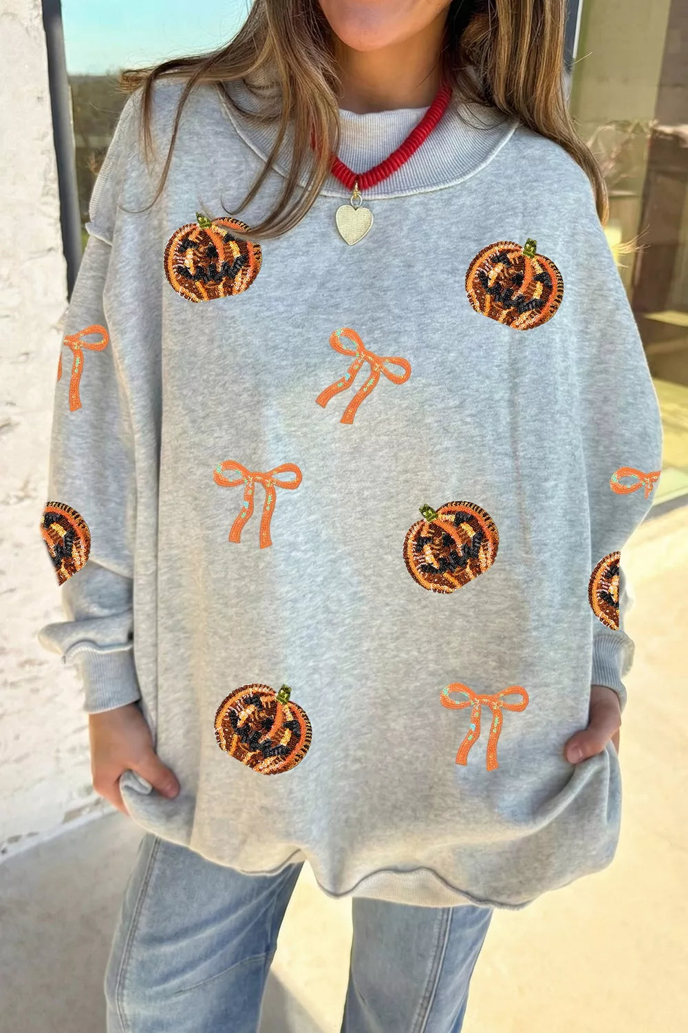 Sequin Pumpkin Face Bow Exposed Seam Halloween Sweatshirt