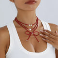 Beaded Bow Necklace with Heart Pendants