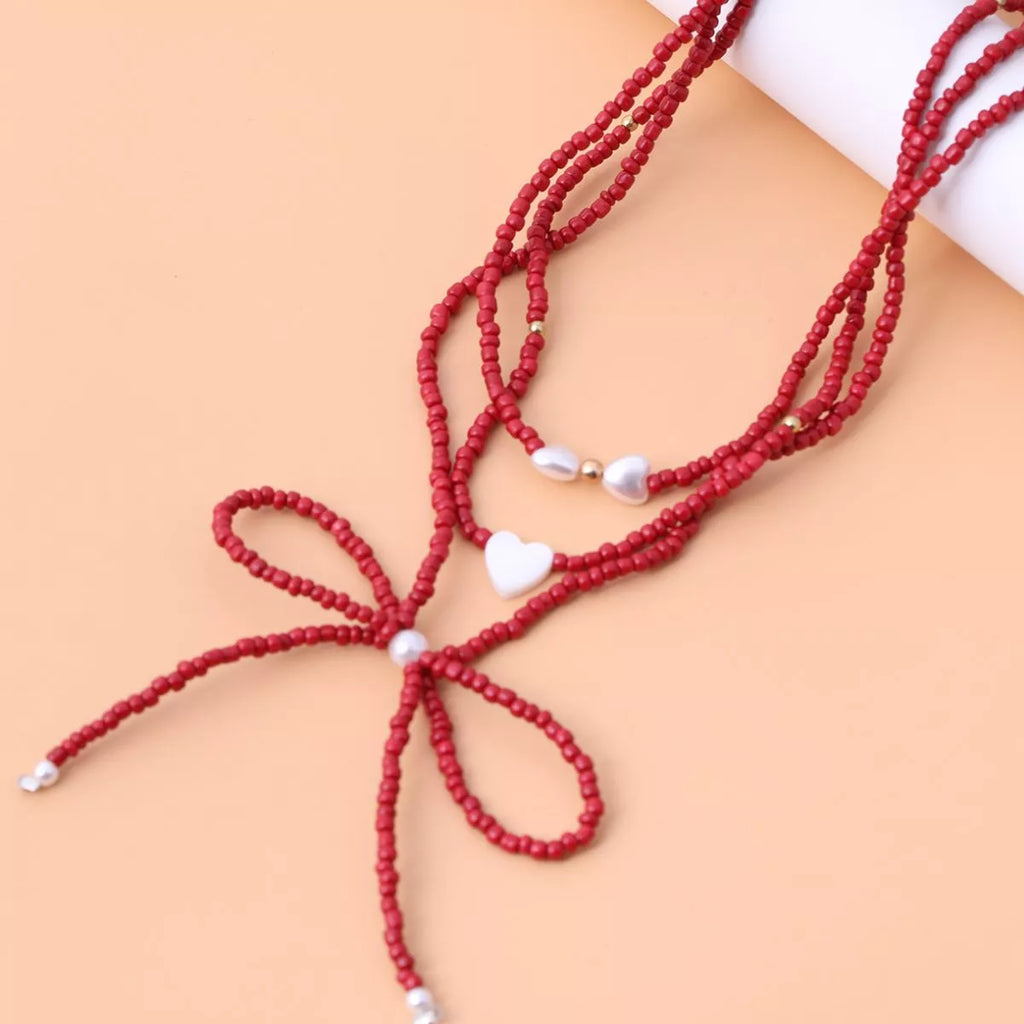 Beaded Bow Necklace with Heart Pendants